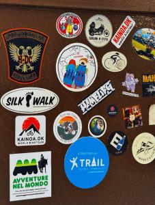 a group of stickers on a refrigerator door at BESQALA in Nukus