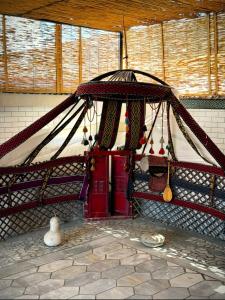 a room with a tent with a bunch of items at BESQALA in Nukus