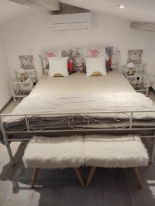 a bed with white sheets and pillows in a bedroom at Maison chez Marthe in Le Muy