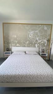 a bedroom with a white bed with a large headboard at Lake Mirror in Lezzeno +20 photos
