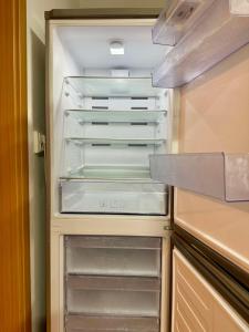 an empty refrigerator with its door open in a kitchen at Joy City Stay Ultracentral in Timişoara +47 photos