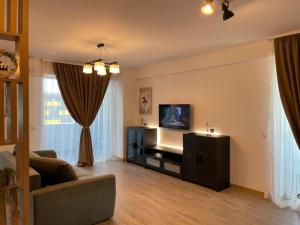 クラヨーヴァにあるDecebal-Residence High View Apartmentのソファとテレビのあるリビングルーム