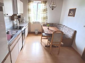 a small kitchen with a table and a dining room at Apartment Weintraube in Rohr im Gebirge