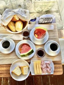 a table with plates of food on a table at Casa Dos Gringobz in Búzios
