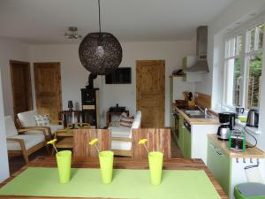 a kitchen with four yellow cups on a table at Boddenfrosch in Wieck