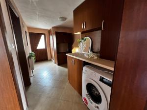 a small kitchen with a washing machine in it at Villa Garden in Kremen