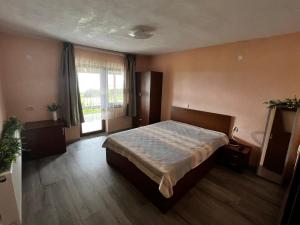 a bedroom with a large bed and a window at Villa Garden in Kremen