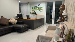 a shop with a couch and a desk in a store at Privacy Residence Lopburi in Lop Buri