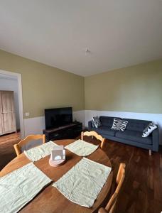 a living room with two tables and a couch at Nid douillet proche de Paris in Sarcelles