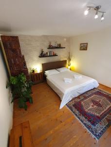 a bedroom with a large bed and a rug at Casa Nautica in Jurilovca