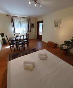 a bedroom with a bed with two towels on it at Casa Nautica in Jurilovca