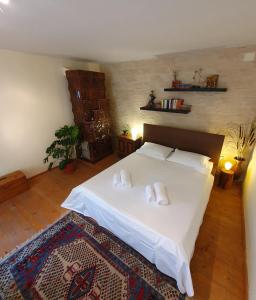 a bedroom with a large white bed with two pillows at Casa Nautica in Jurilovca