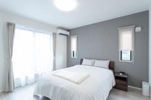Mova Villa Ozu客房内的一张或多张床位