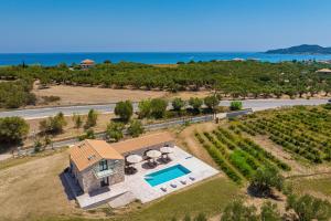 an aerial view of a house with a swimming pool at Villa Nava - Nestled in Olive Trees with Private Pool, by ZanteWize in Alykes