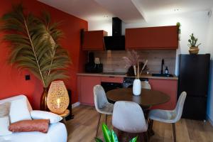 a kitchen and living room with a table and chairs at La Casa, Suite mexicaine d'exception à Saumur in Saumur