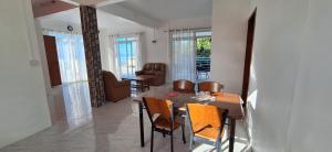 a dining room with a table and chairs at Kyo Villa in Quatre Vents +20 photos