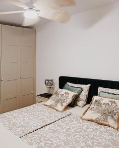 a bedroom with a bed with pillows and a ceiling at La Mata Apartment, Spain in La Mata +66 photos