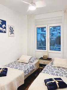 a bedroom with two beds and a window at La Mata Apartment, Spain in La Mata