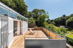 an outdoor deck with a television on a house at Casas do Sarela by Upper Luxury Housing in Santiago de Compostela