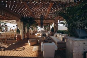 a living room with couches and tables and a wooden ceiling at Le Sidi - A TLT Signature Hotel in El Alamein