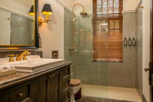 a bathroom with a sink and a shower at The Grand Hotel - Heritage Grand in Nuwara Eliya
