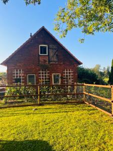 a brick house with a fence in front of it at Heide-Huus Landliebe in Soltau