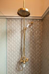 a shower with a shower head in a bathroom at The Grand Hotel - Heritage Grand in Nuwara Eliya