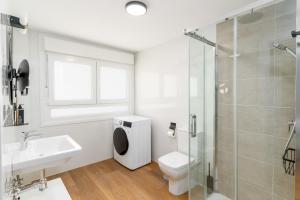 a bathroom with a toilet and a sink and a shower at Limehome Oviedo Calle Postigo Bajo in Oviedo +43 photos