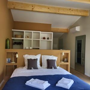 a bedroom with a large bed with two towels on it at Villa Hélène in Aix-en-Provence
