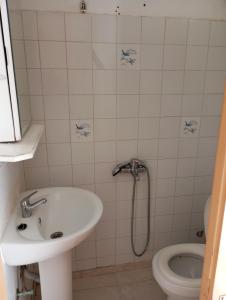 a bathroom with a sink and a toilet at Nikoletta in Ancient Epidauros