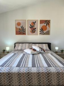 a bedroom with a bed with two pillows on it at La Madama • Casa Vacanze in Porto Torres