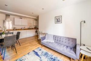 a living room with a couch and a table at Contemporary Abbey Yard by Prescott Apartments in Abingdon +19 photos