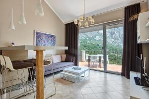 a living room with a couch and a table at Apartmani with POOL and VIEW in Gornji Orahovac