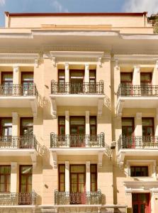 a building with balconies on the side of it at Gatto Perso Luxury Studio Apartments in Thessaloniki