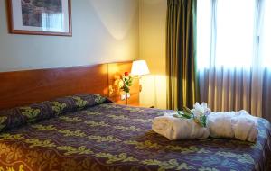 a hotel room with a bed with flowers on it at Zenit Diplomatic in Andorra la Vella