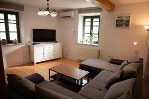 a living room with a couch and a tv at Villa Maria in Pašman