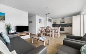 a living room with a couch and a table at Deck 47 in Olpenitz
