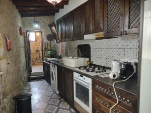 a kitchen with a sink and a stove top oven at The Little Stone House -Kucuk Das Ev - in Kyrenia