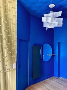a blue room with a mirror and a blue wall at La Rêverie - Deluxe Apartment - SPA - Place du Forum in Reims