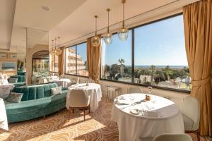 a restaurant with two tables and a large window at Hotel Quinta do Lago in Quinta do Lago