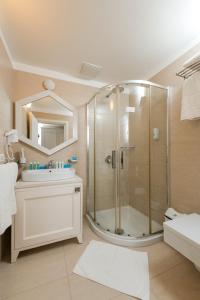 a bathroom with a shower and a sink at Soleil Village & Villas in Jal +91 photos
