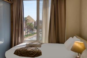 Voodi või voodid majutusasutuse Khattab Pyramids View Hotel toas