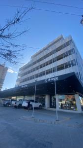 a large building with cars parked in front of it at Departamento TIERRA VI in Salta