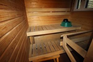 a sauna with a green kettle on top of it at MajoitusYkk&ouml;nen in Raahe