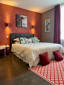 a bedroom with a large bed with red walls at VILLA BEAUSEJOUR in Cannes