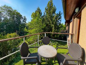 a table and chairs sitting on a balcony at Park Hotel Popovicky in Popovičky