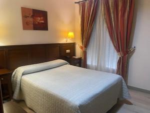Posteľ alebo postele v izbe v ubytovaní Hostal Carmen