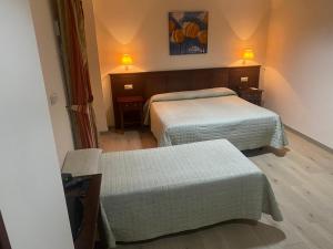 Posteľ alebo postele v izbe v ubytovaní Hostal Carmen