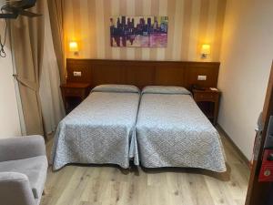 Posteľ alebo postele v izbe v ubytovaní Hostal Carmen