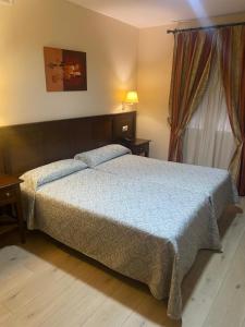Posteľ alebo postele v izbe v ubytovaní Hostal Carmen